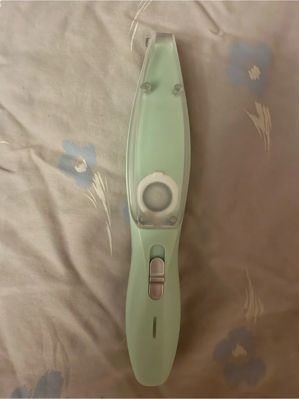 This a green electric pet shaver designed for trimming hair on dogs and cats.